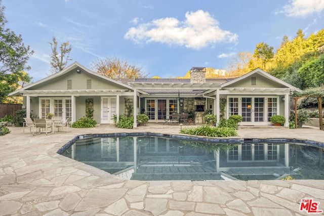 rear view of house featuring french doors and a patio area