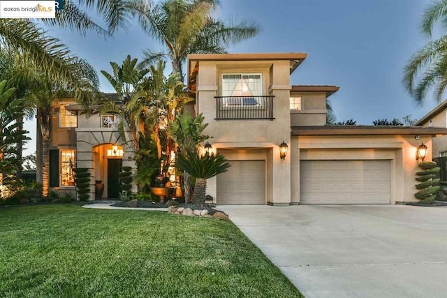 mediterranean / spanish-style house featuring a front yard, a garage, and a balcony