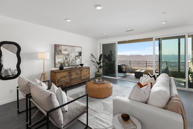 living area featuring recessed lighting and baseboards