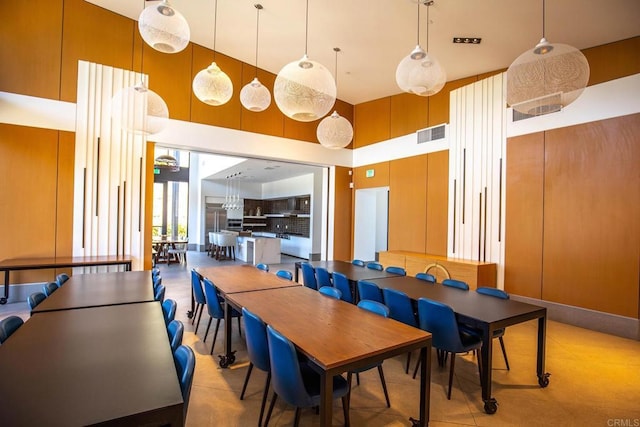 dining space with a towering ceiling and visible vents