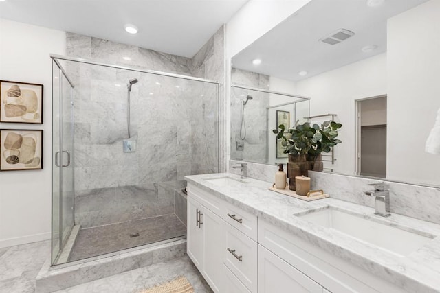 full bathroom featuring double vanity, a sink, and a shower stall