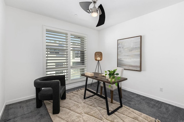 office area with carpet flooring, a ceiling fan, and baseboards