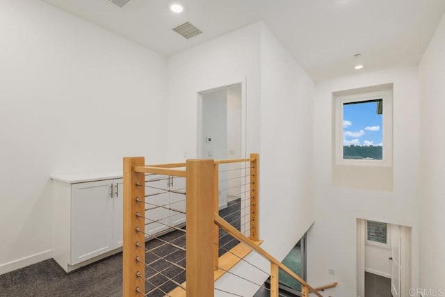 stairway featuring baseboards, carpet, visible vents, and recessed lighting