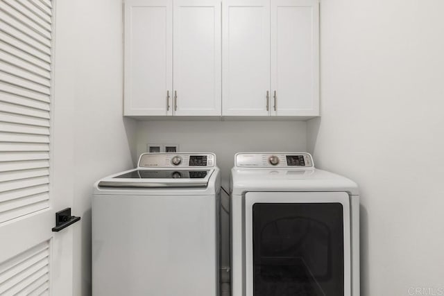 laundry room with washer and dryer and cabinet space