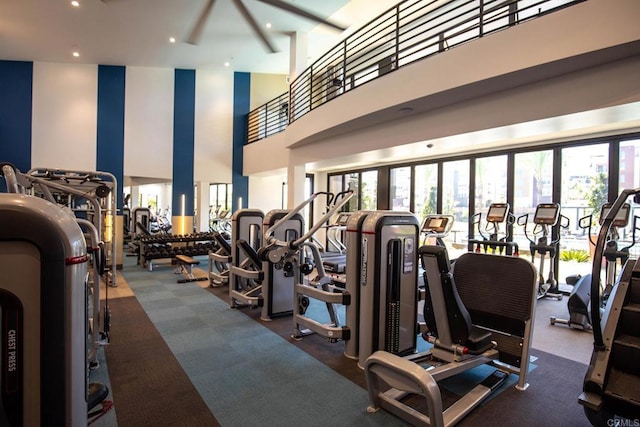 gym featuring a high ceiling, carpet flooring, and recessed lighting