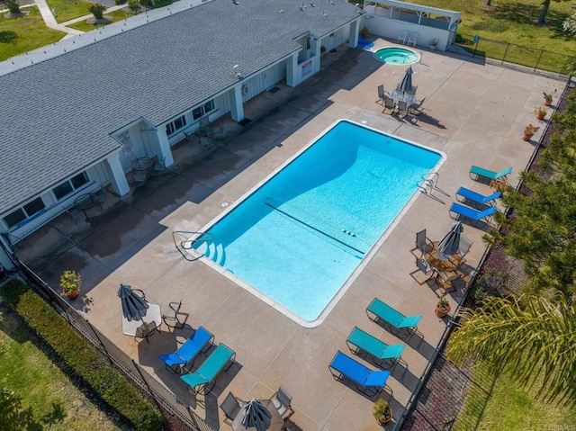 view of swimming pool with a patio area and a hot tub