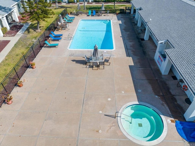 view of swimming pool with a hot tub and a patio area