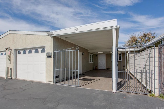 view of front of house featuring a garage and a carport