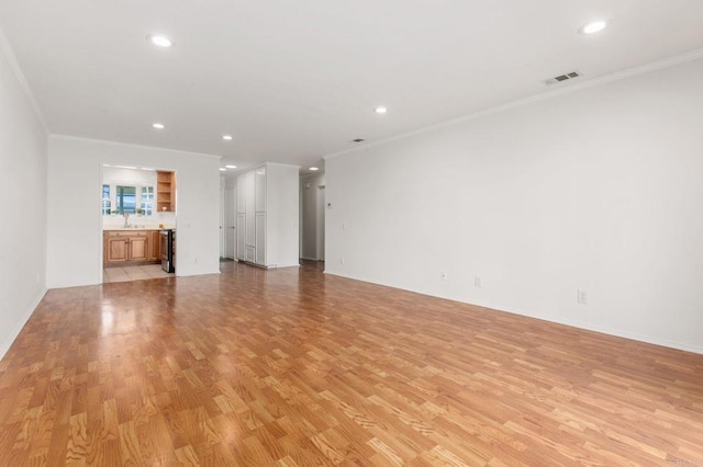 unfurnished living room featuring light hardwood / wood-style flooring and ornamental molding