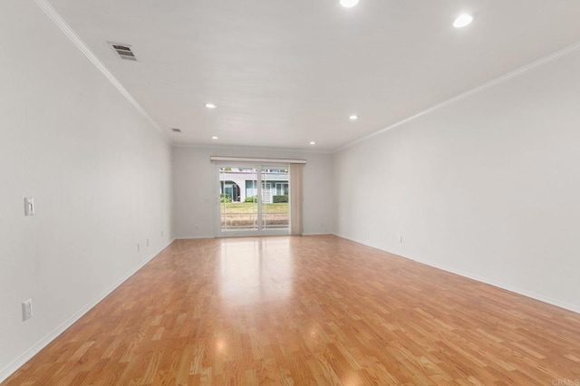 unfurnished room featuring light hardwood / wood-style flooring and ornamental molding