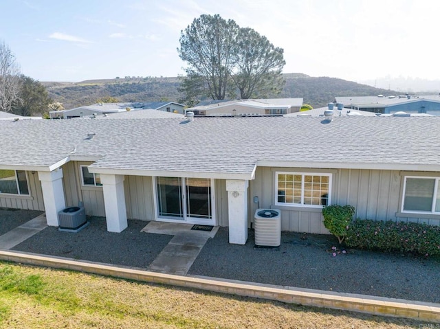 back of property featuring a patio, a mountain view, and central AC unit