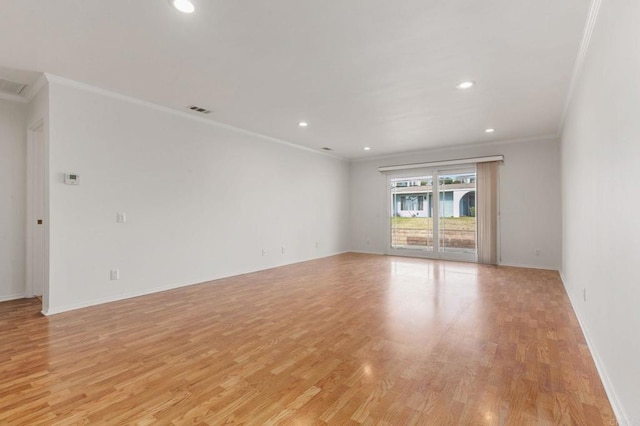 unfurnished room with crown molding and light hardwood / wood-style flooring