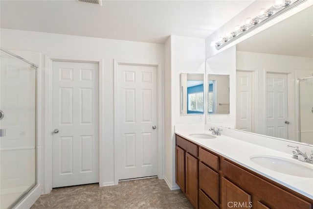 bathroom featuring an enclosed shower and vanity