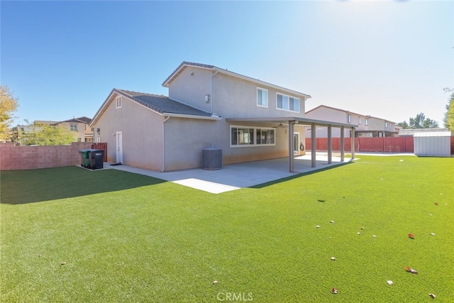 rear view of property with a patio, cooling unit, and a yard