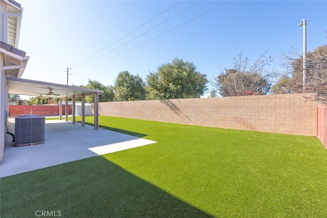 view of yard featuring central AC and a patio area