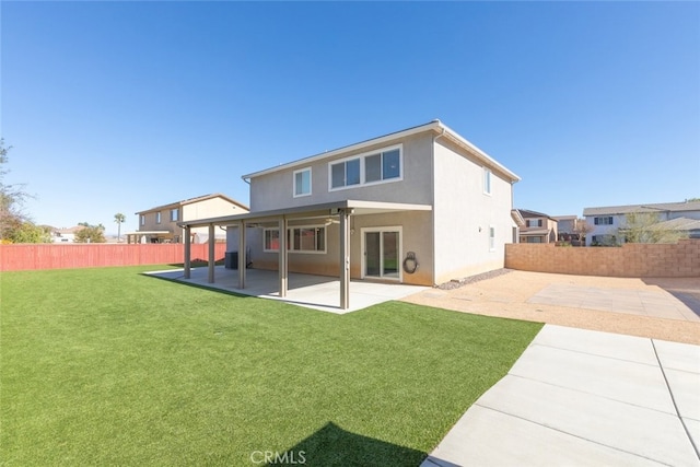 rear view of house featuring a patio and a yard