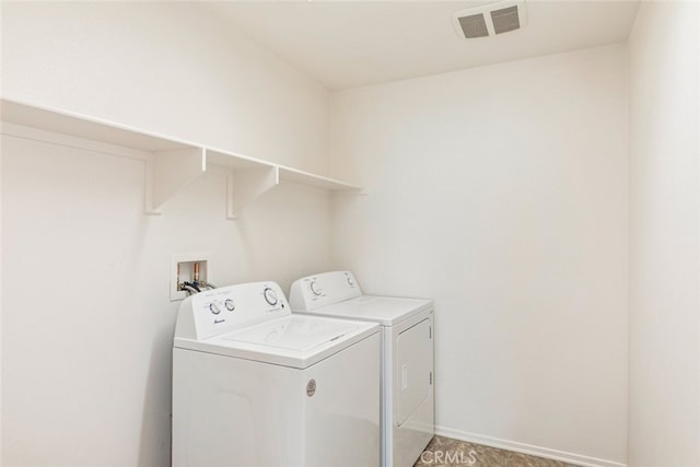 clothes washing area with separate washer and dryer