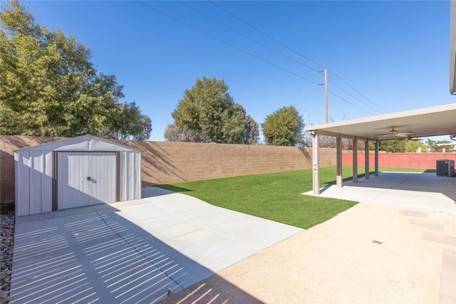 view of patio with ceiling fan and a shed