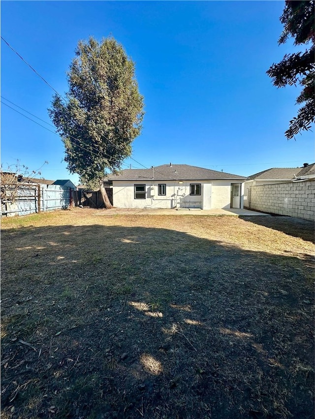 rear view of house with a lawn