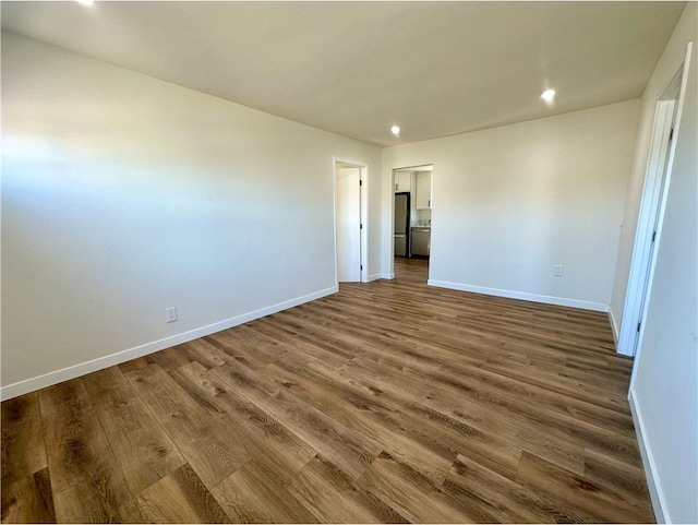 unfurnished room with wood-type flooring