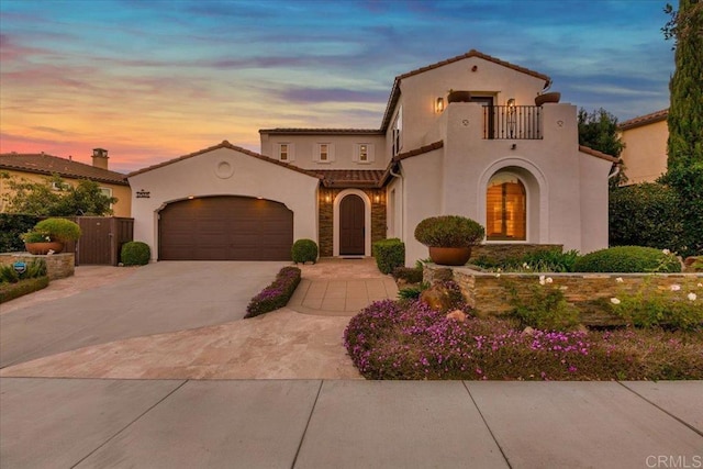 mediterranean / spanish-style home with a balcony and a garage