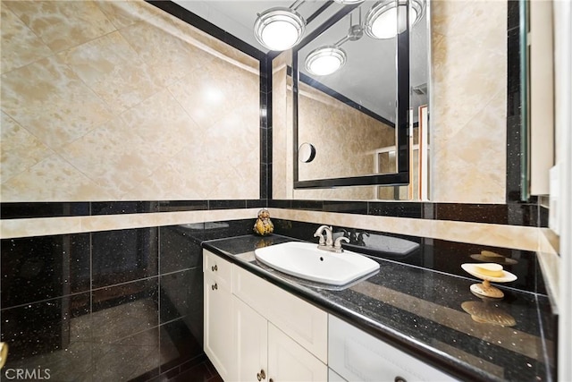 bathroom featuring tile walls and vanity