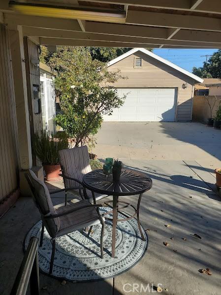 view of patio / terrace with a garage and an outdoor structure