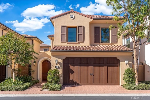 mediterranean / spanish-style home with a garage