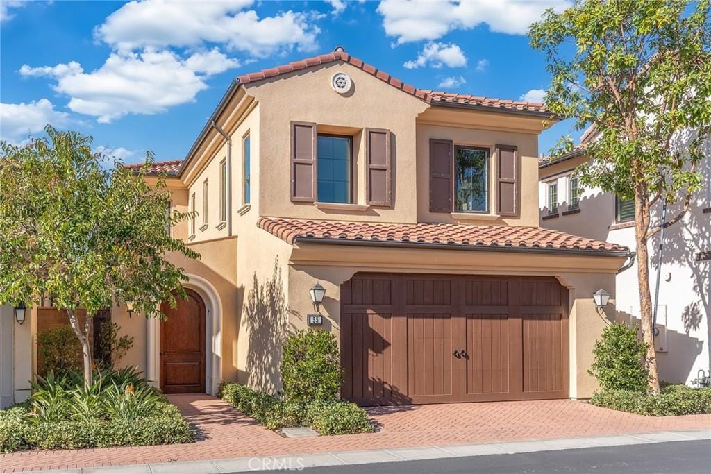 mediterranean / spanish-style house featuring a garage