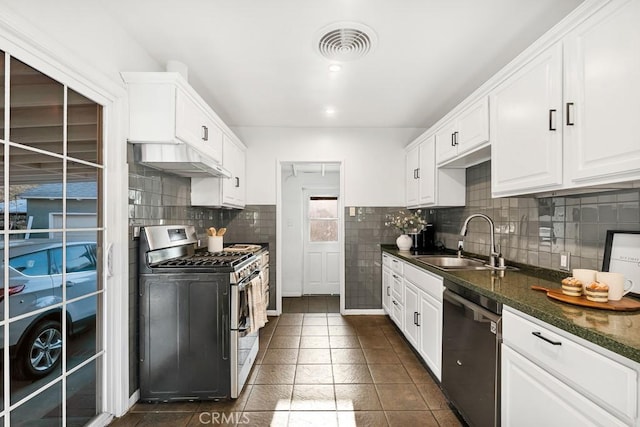 kitchen with white cabinetry, dishwasher, stainless steel gas stove, sink, and dark stone countertops