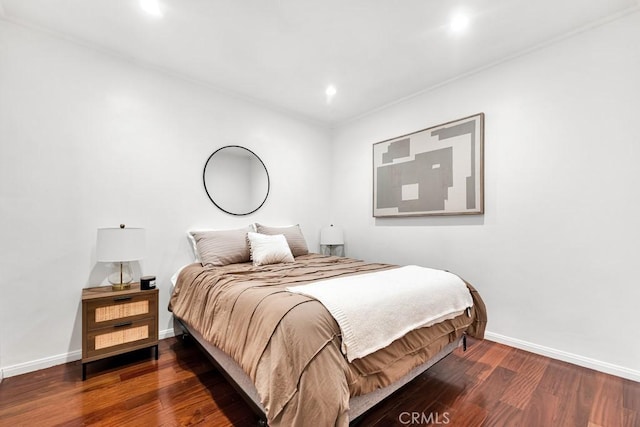 bedroom with dark hardwood / wood-style flooring