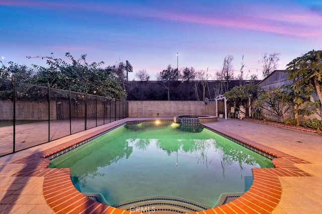 pool at dusk with a patio