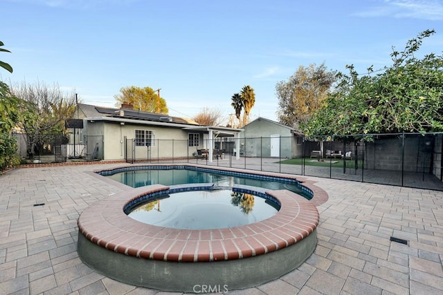 view of pool with an in ground hot tub and a patio