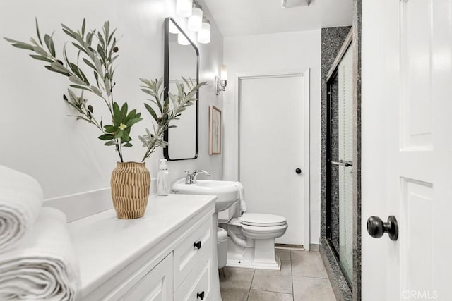 bathroom featuring tile patterned floors, toilet, a shower with shower door, and sink