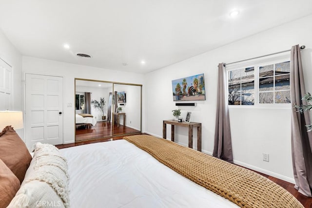 bedroom featuring dark hardwood / wood-style floors and a closet