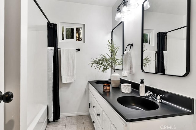 bathroom featuring vanity, tile patterned floors, and shower / bath combo with shower curtain