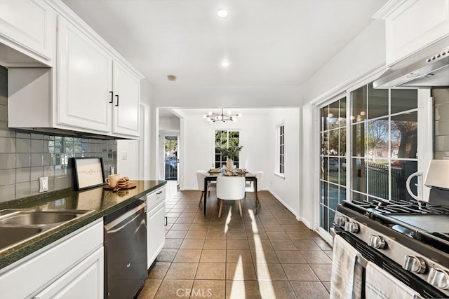 kitchen featuring stainless steel appliances, tile patterned floors, backsplash, extractor fan, and white cabinets