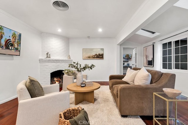 living room with a fireplace, hardwood / wood-style flooring, and crown molding