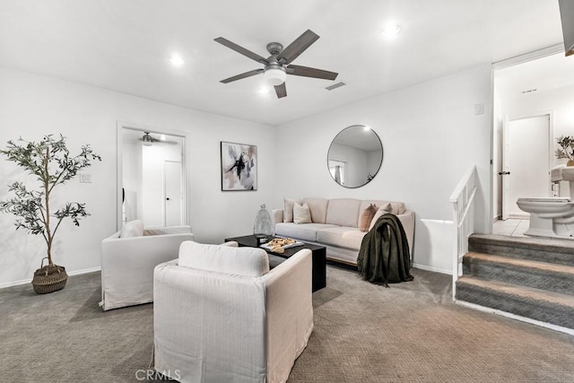 carpeted living room with ceiling fan