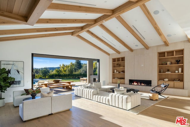 living room with high vaulted ceiling, built in shelves, a fireplace, beamed ceiling, and wood-type flooring