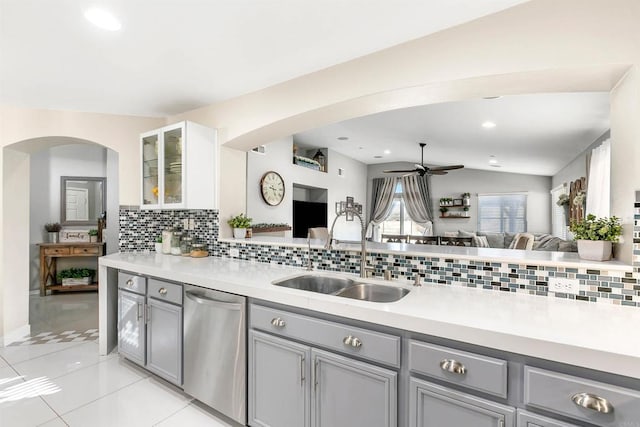 kitchen with stainless steel dishwasher, ceiling fan, sink, gray cabinets, and lofted ceiling