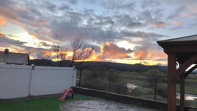 yard at dusk with a patio area