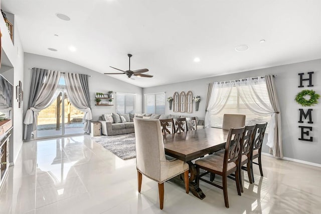 dining space with ceiling fan and vaulted ceiling