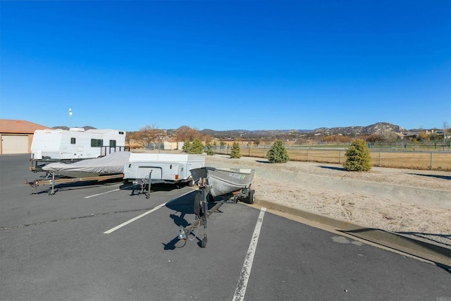 view of car parking featuring a mountain view