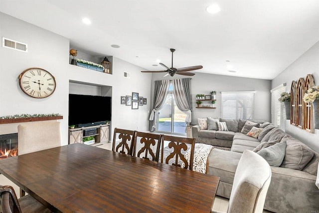 dining room with ceiling fan and vaulted ceiling