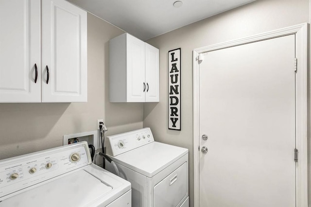 laundry area featuring cabinets and separate washer and dryer