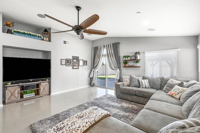 living room featuring ceiling fan, lofted ceiling, and light tile patterned floors