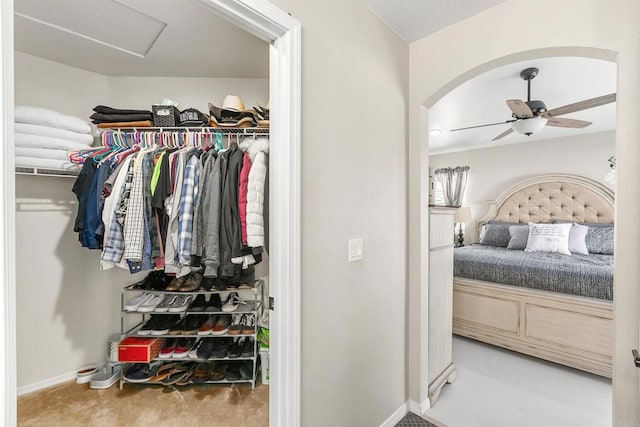 spacious closet featuring light carpet and ceiling fan