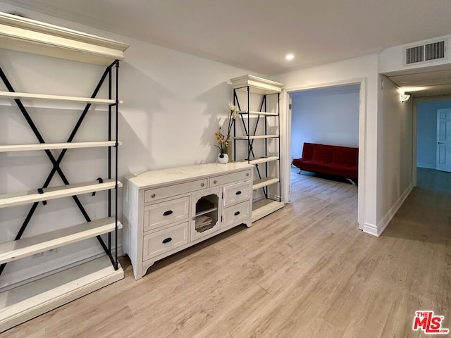 corridor with light hardwood / wood-style floors