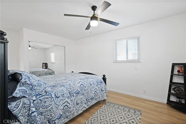 bedroom featuring ceiling fan, a closet, and hardwood / wood-style floors